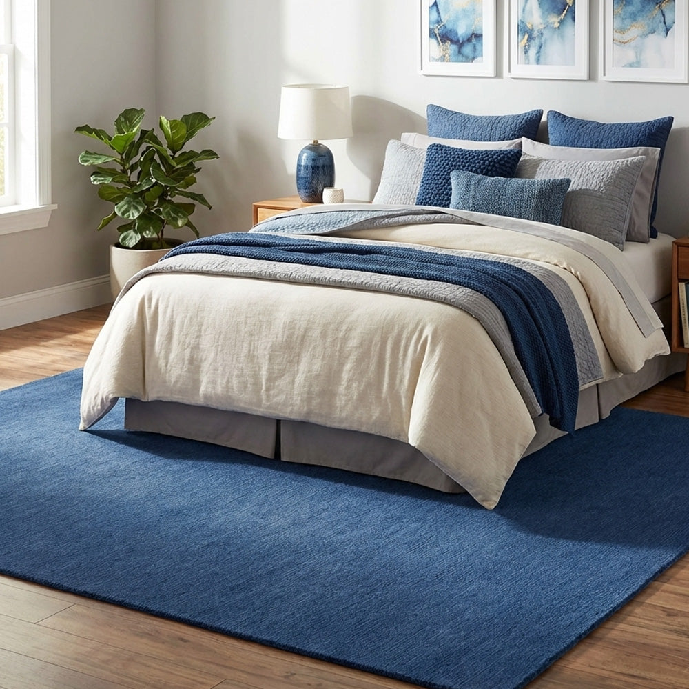 blue wool rug in bedroom under bed