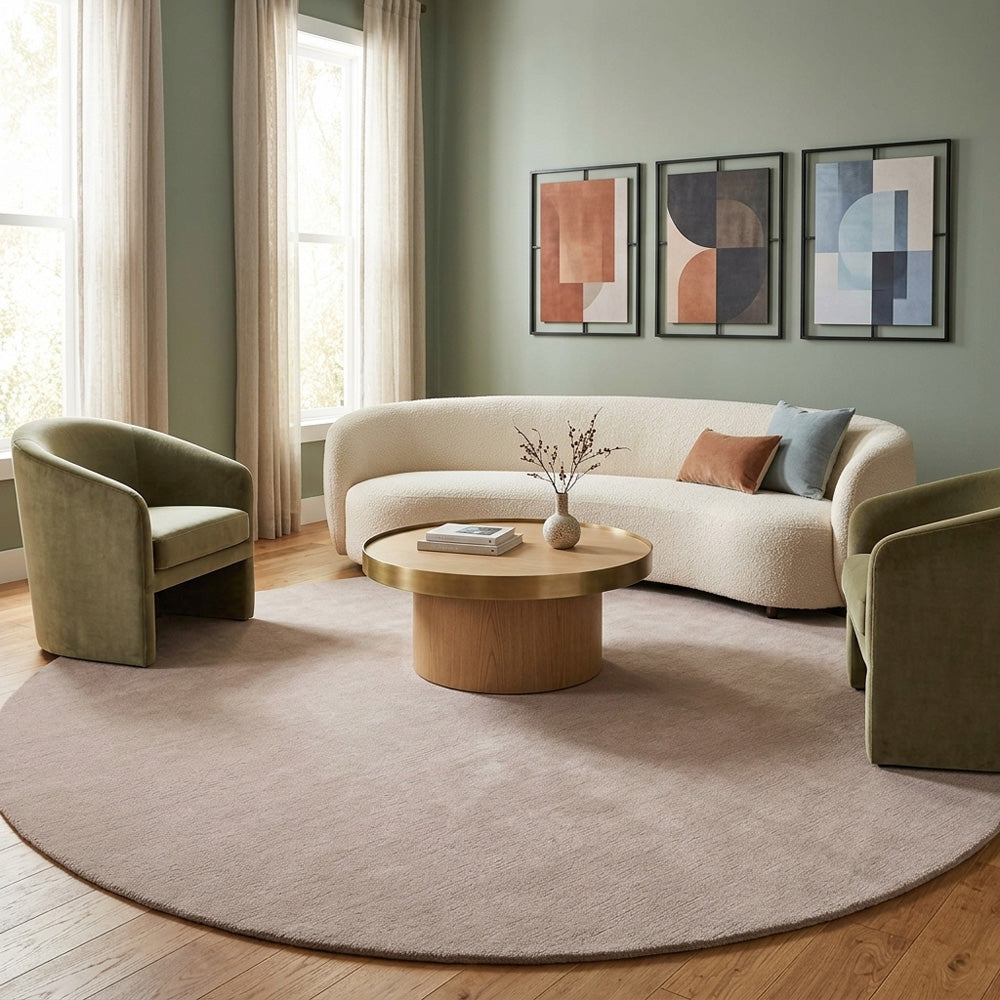 Taupe plain round wool rug in living room