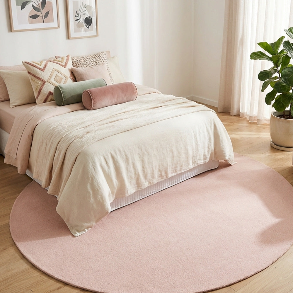 Pink round wool rug in modern bedroom