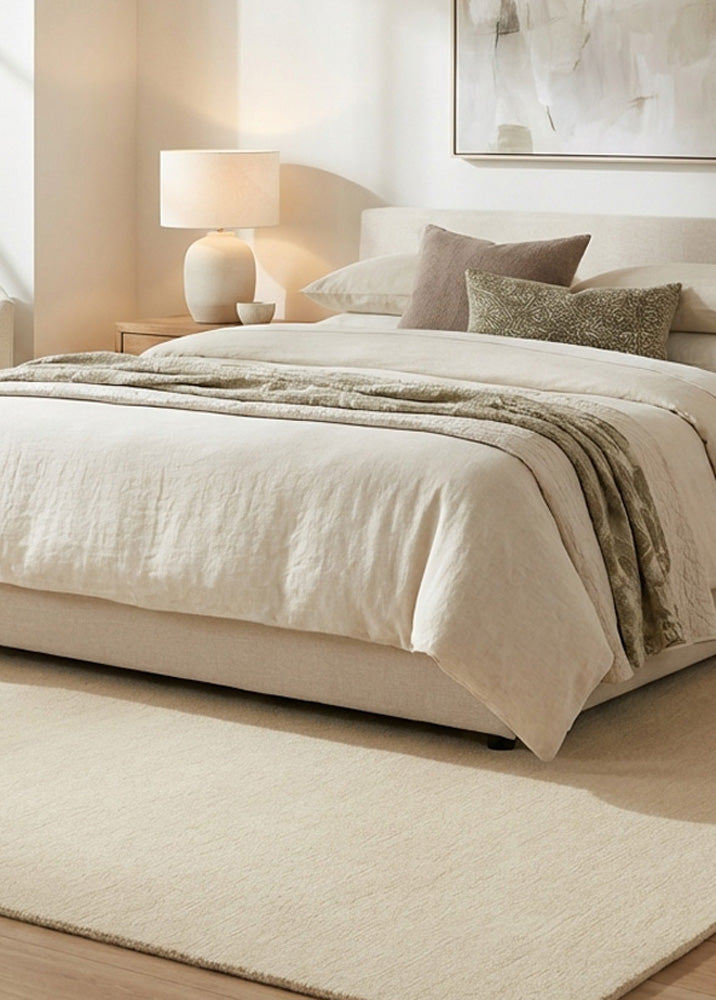 Hand tufted cream wool rug in bedroom