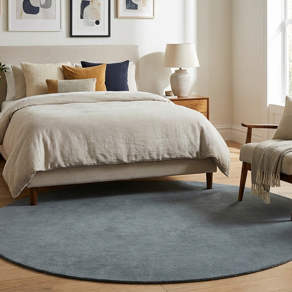 Grey round wool rug in modern bedroom