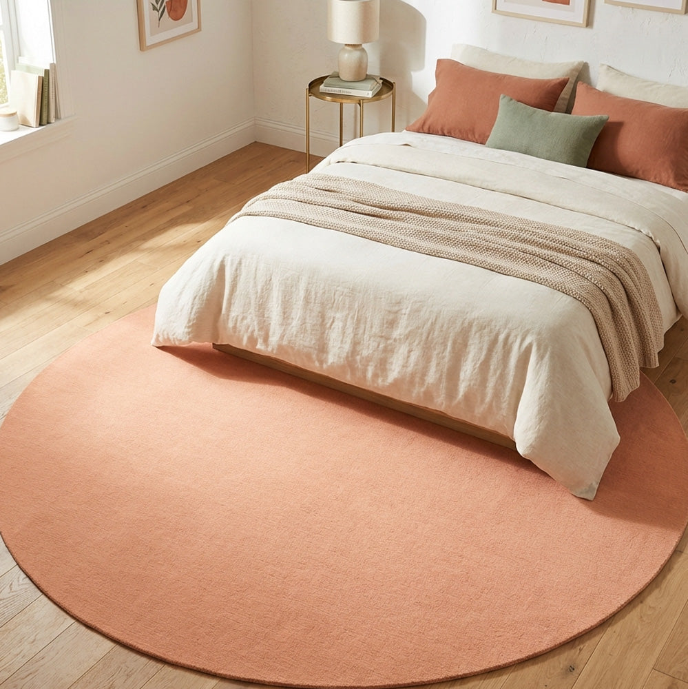 Hand tufted peach round wool rug in modern bedroom