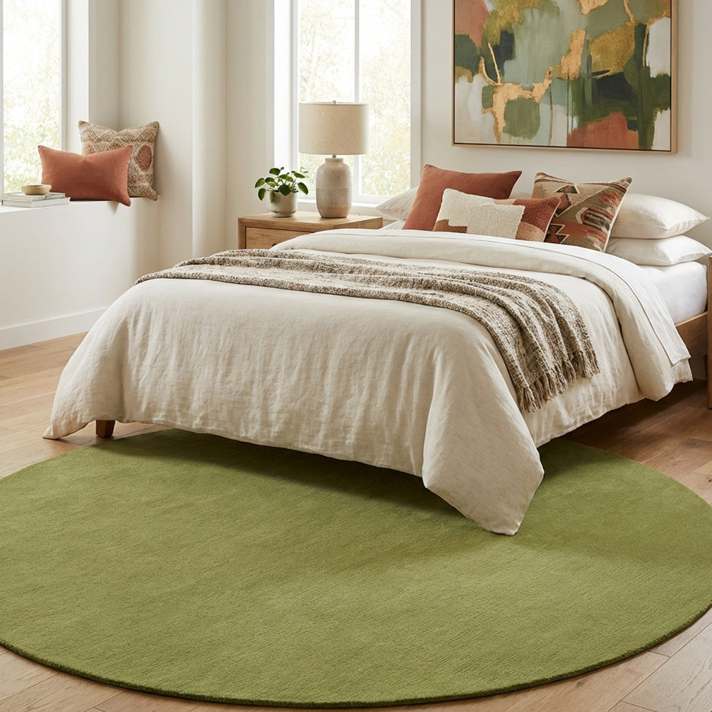 Green round wool rug in bedroom