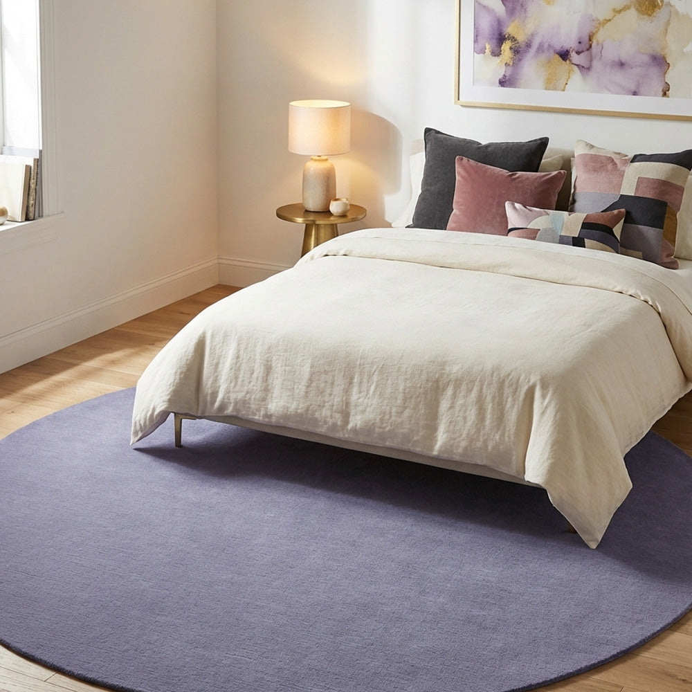 Hand tufted round wool rug in modern bedroom