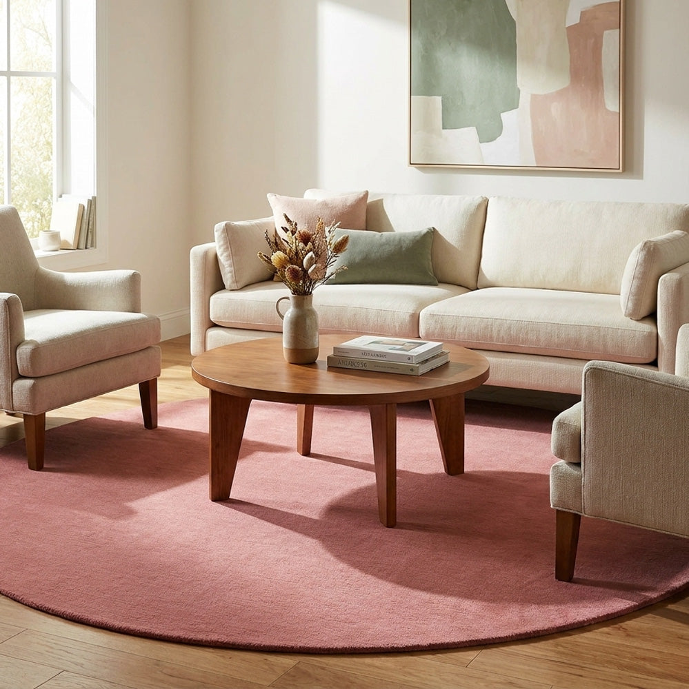 Dark pink round wool rug in modern living room