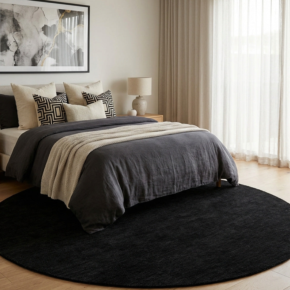 black round wool rug in modern bedroom