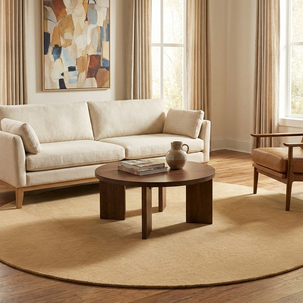 Hand tufted light beige round wool rug in living room