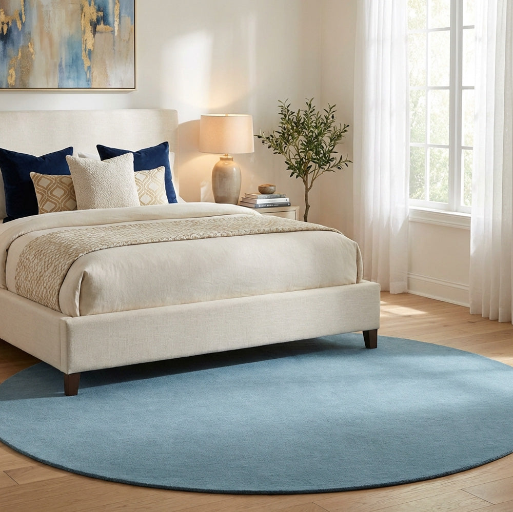 Blue round wool rug in modern bedroom