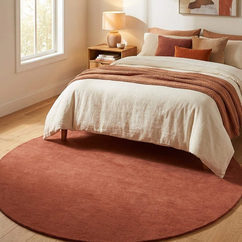 orange round wool rug in bedroom