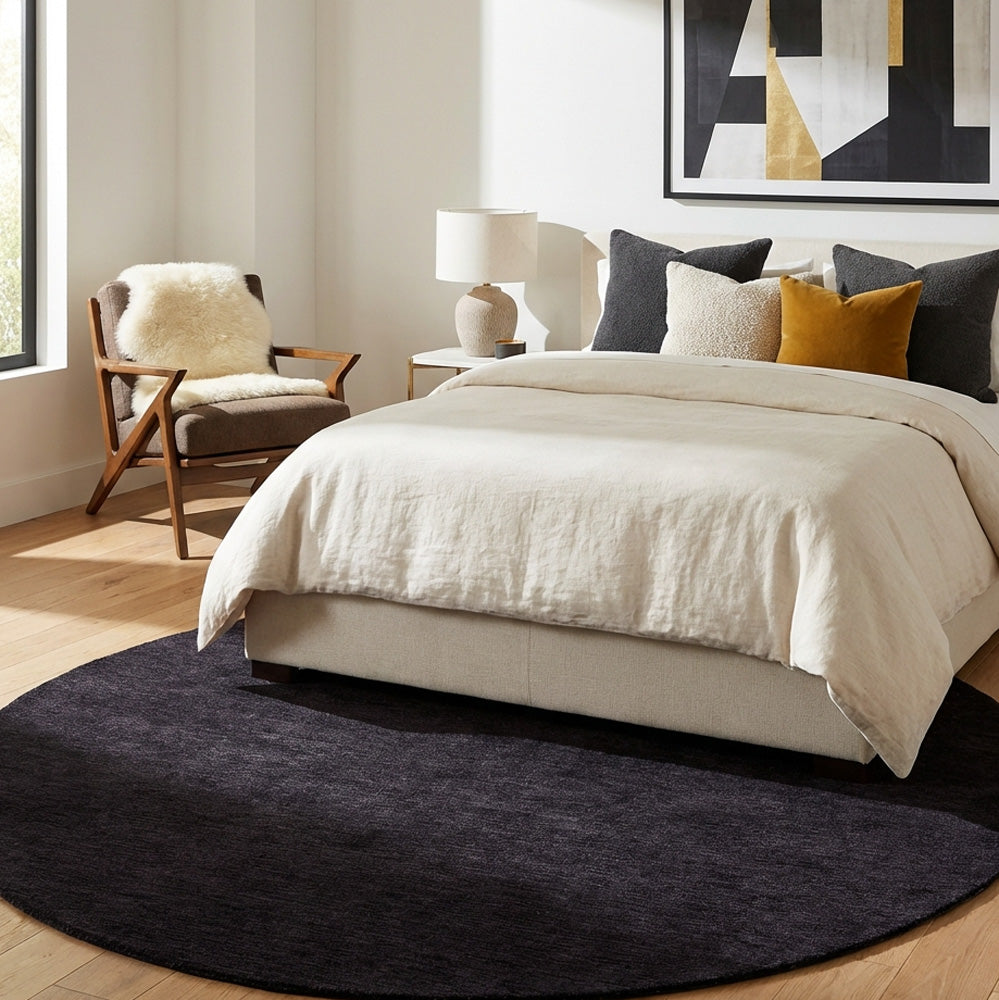 Dark purple round wool rug in modern bedroom