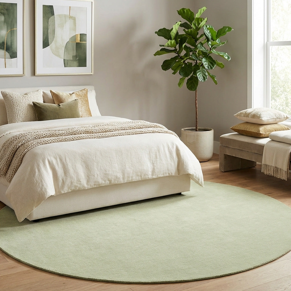 Sage green round wool rug in modern bedroom