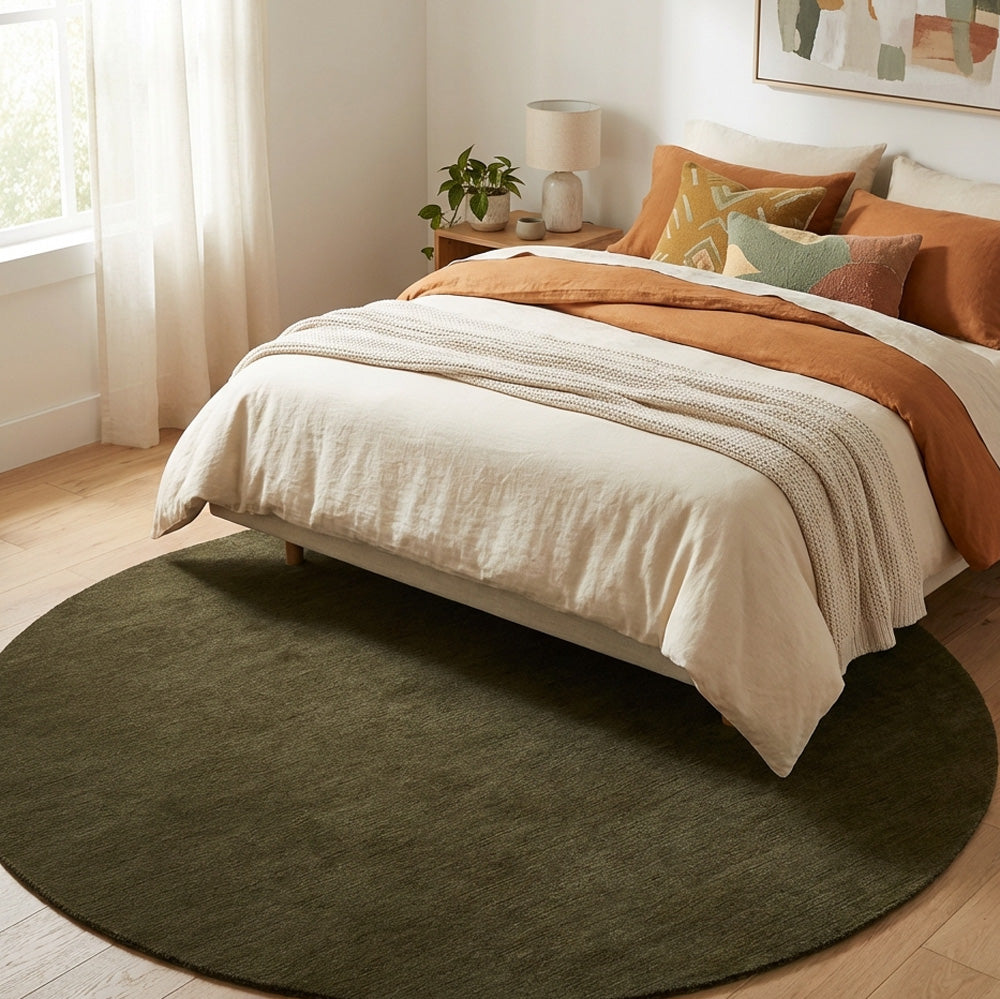 Dark olive green round wool rug in bedroom