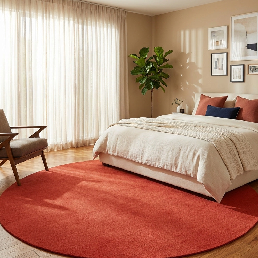Red round wool rug in bedroom