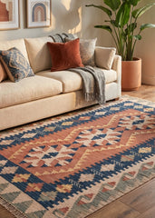 Living room with a beige sofa, patterned kilim rug, and decorative elements.