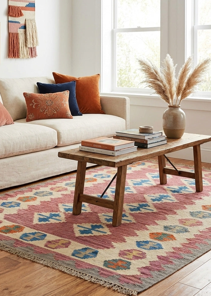 Living room with a beige sofa, wooden coffee table, and colorful kilim rug.