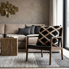 Black and tan lattice cowhide cushion styled on a modern accent chair in a contemporary living room