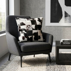 Black and white checkered cowhide cushion styled on a modern charcoal armchair