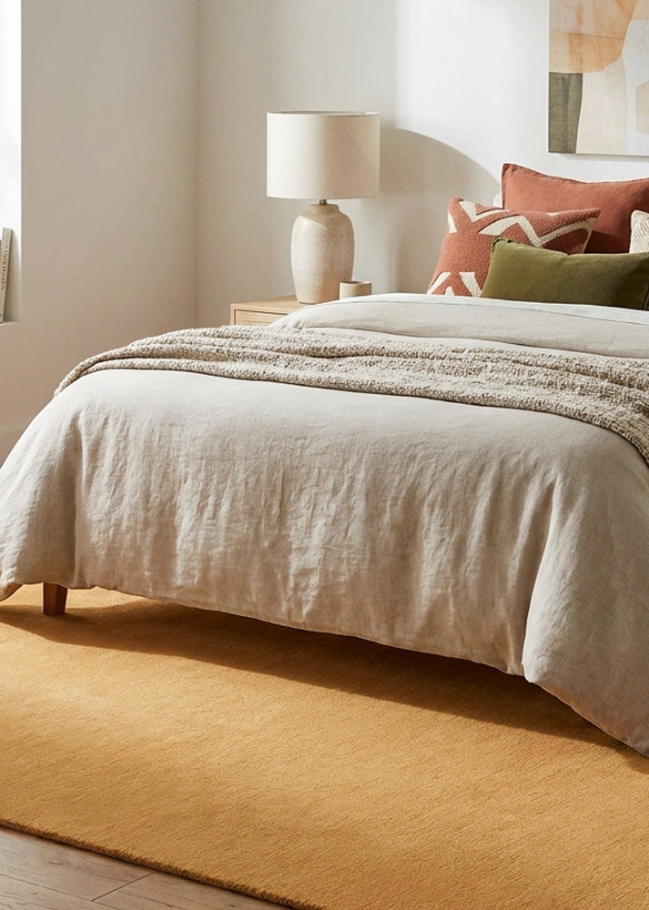 Mustard yellow wool rug in bedroom