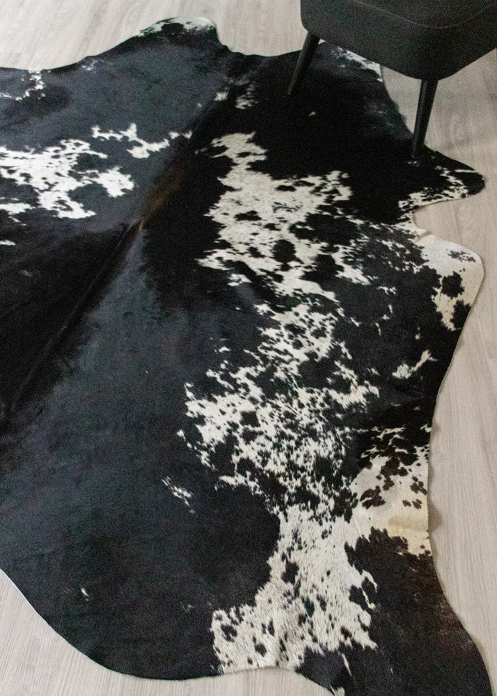 large real cow hide rug on floor