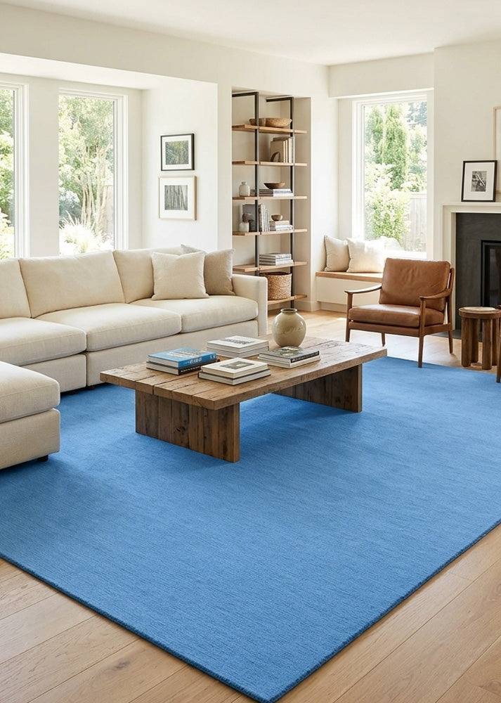 Minimalist Wool Rug in Denim Blue styled in a modern living room