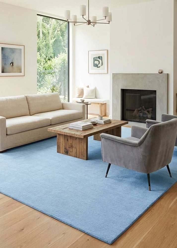 Minimalist Wool Rug in Dusty Blue styled in a modern living room